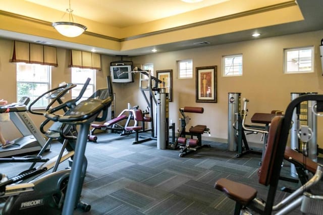 gym featuring dark colored carpet and a wealth of natural light