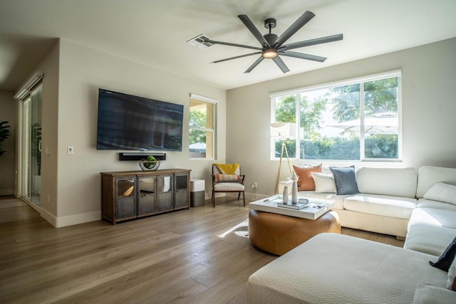 living room featuring ceiling fan and wood-type flooring