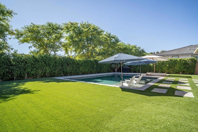 view of swimming pool with a lawn