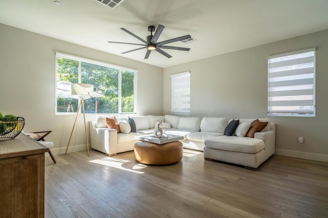 living room featuring light hardwood / wood-style flooring and ceiling fan