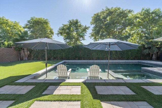 view of swimming pool with a lawn and an in ground hot tub