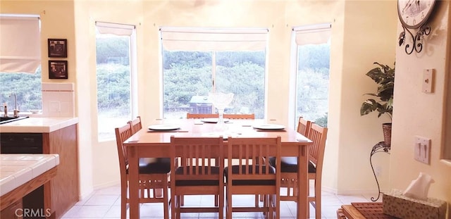 dining area with light tile patterned flooring and a healthy amount of sunlight