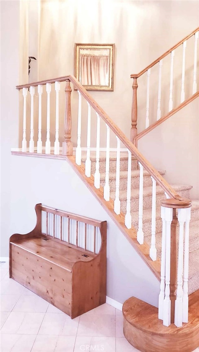 stairs featuring tile patterned floors