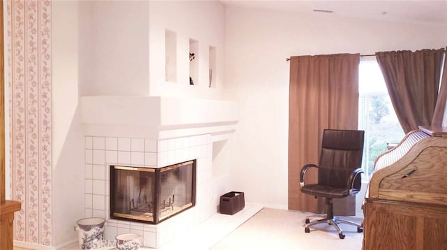 interior space featuring a tiled fireplace