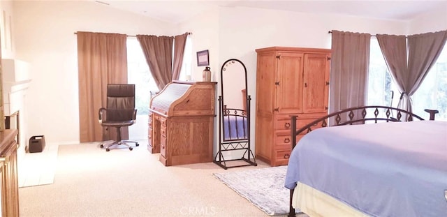 bedroom featuring light colored carpet and lofted ceiling