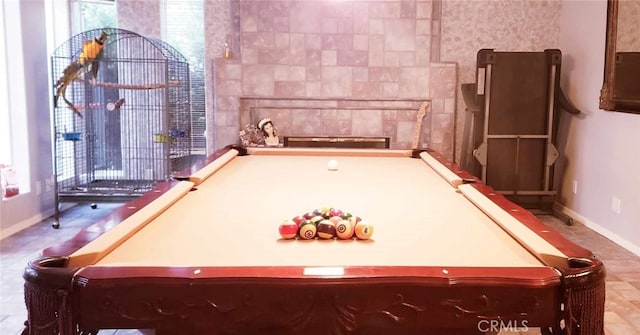 recreation room featuring a tiled fireplace and billiards