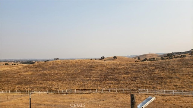 view of yard with a mountain view and a rural view