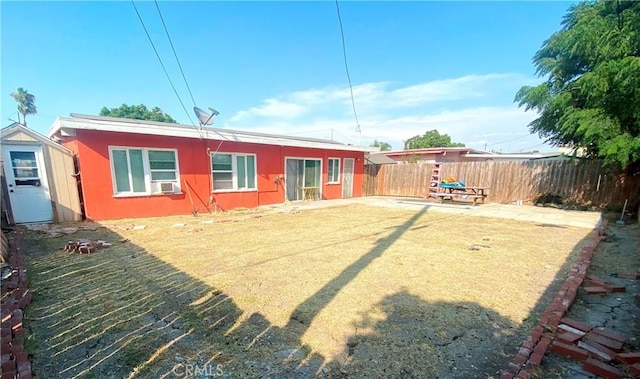 1718 W 166th St, Compton, CA 90220 - rear view of property featuring a fenced backyard, a shed, cooling unit, and stucco siding