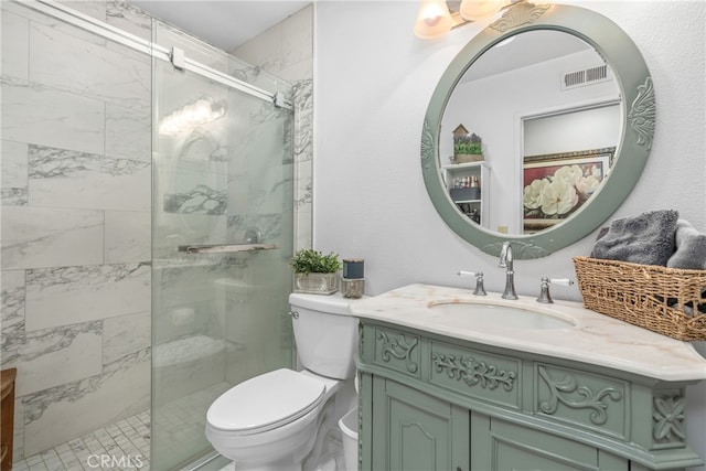 bathroom featuring vanity, toilet, and walk in shower