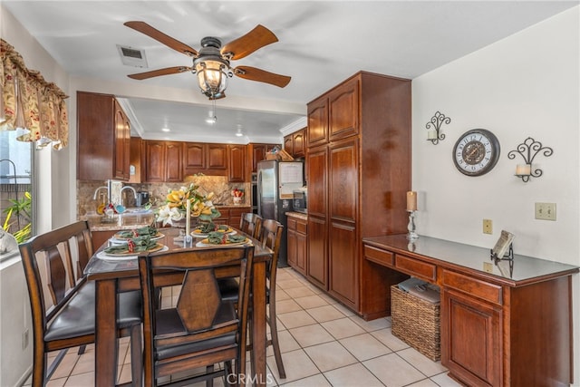 kitchen with decorative backsplash, ceiling fan, stainless steel appliances, and light tile patterned floors