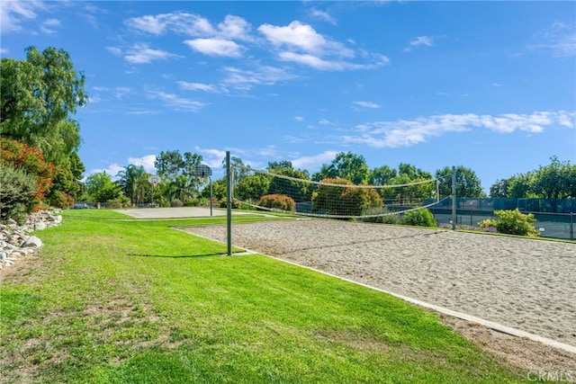 view of home's community featuring a lawn and volleyball court