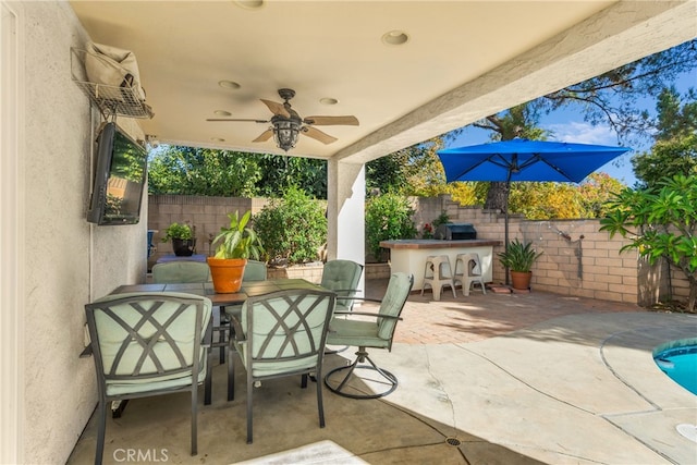 view of patio / terrace with a bar and ceiling fan