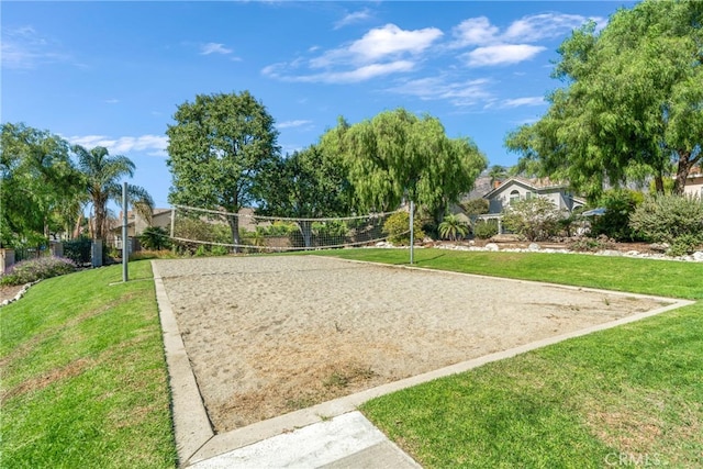 view of community featuring volleyball court and a lawn