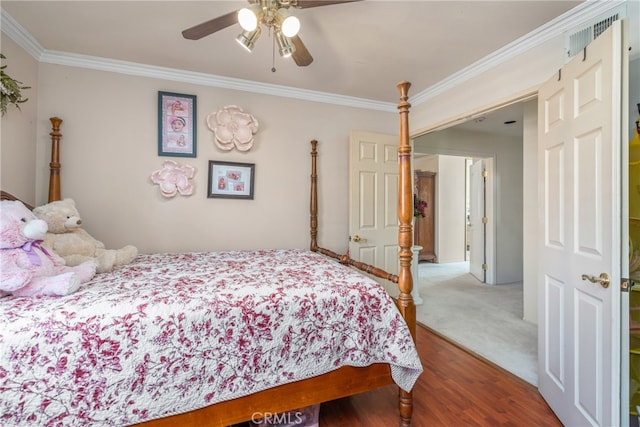 bedroom featuring hardwood / wood-style flooring, ceiling fan, and crown molding