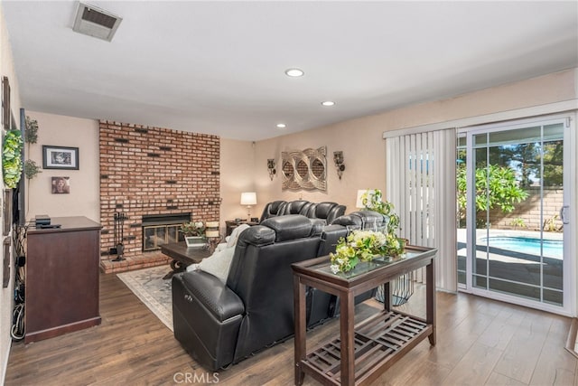 living room with hardwood / wood-style floors and a fireplace