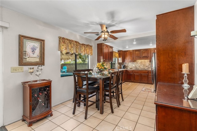 dining space with sink, ceiling fan, and light tile patterned floors