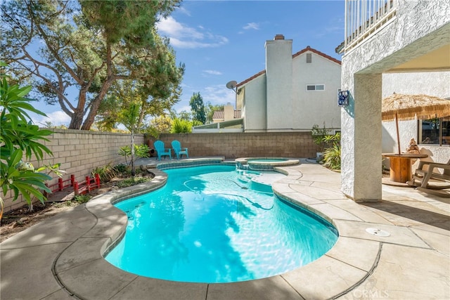 view of pool featuring an in ground hot tub and a patio area