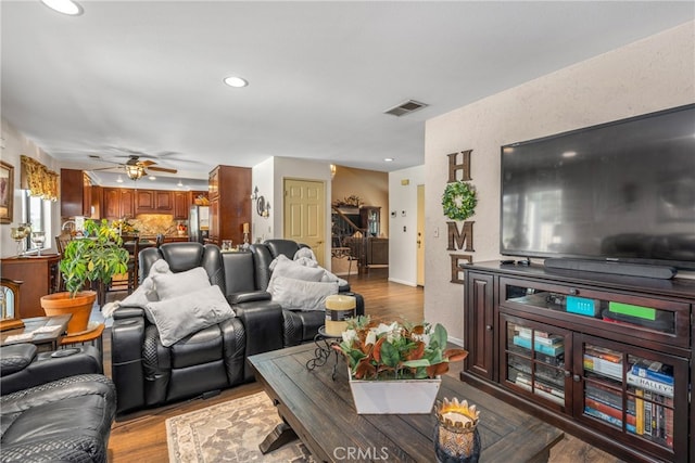 living room featuring light wood-type flooring and ceiling fan