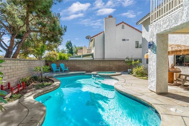 view of swimming pool with an in ground hot tub and a patio area