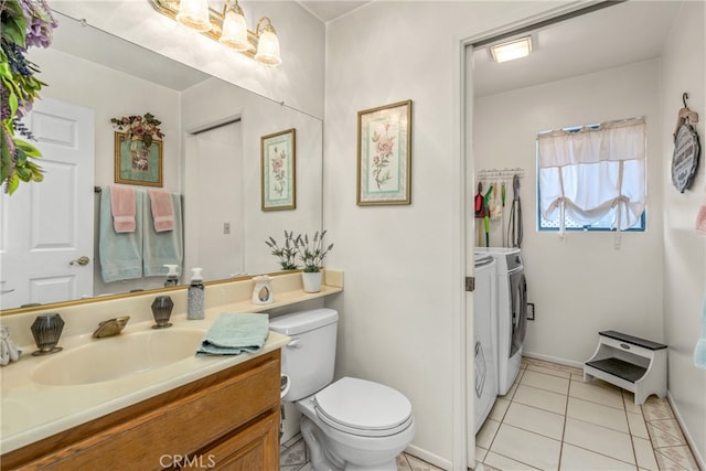 bathroom with vanity, washer and dryer, toilet, and tile patterned floors