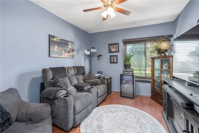 living room with ceiling fan, wood-type flooring, and beverage cooler