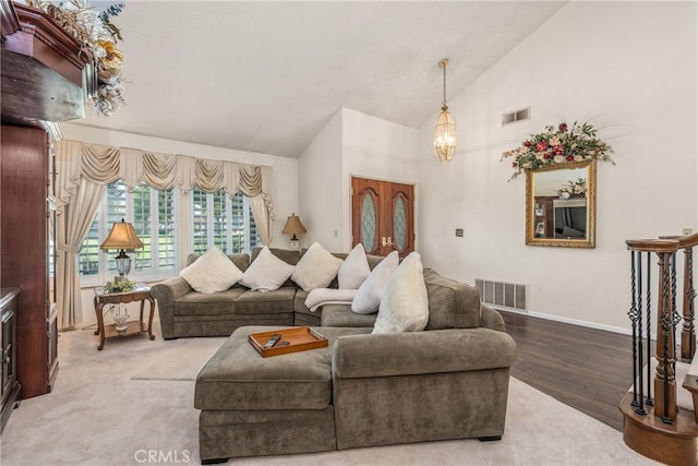 living room featuring hardwood / wood-style flooring and high vaulted ceiling