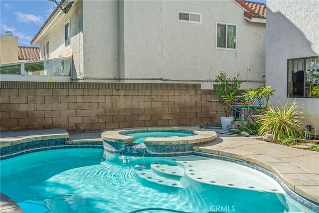 view of pool with an in ground hot tub