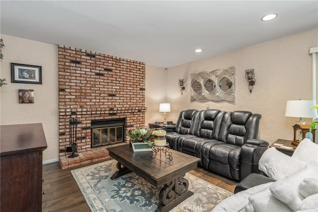 living room with a fireplace and dark hardwood / wood-style floors