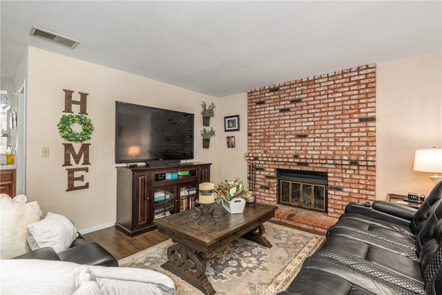 living room featuring a fireplace and dark hardwood / wood-style floors