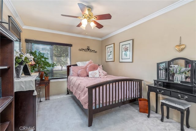 carpeted bedroom featuring ornamental molding and ceiling fan