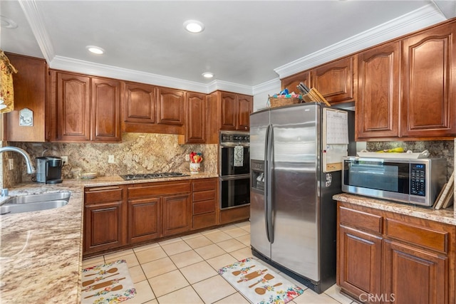 kitchen featuring ornamental molding, sink, light stone countertops, light tile patterned floors, and appliances with stainless steel finishes