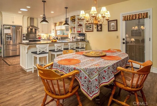 dining room featuring recessed lighting, an inviting chandelier, and wood finished floors