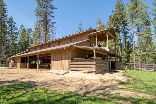 rear view of property with an outbuilding