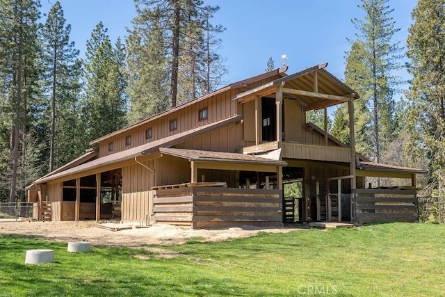 back of property featuring an outdoor structure