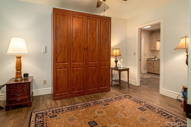 bedroom featuring dark wood-type flooring, ceiling fan, and ensuite bathroom