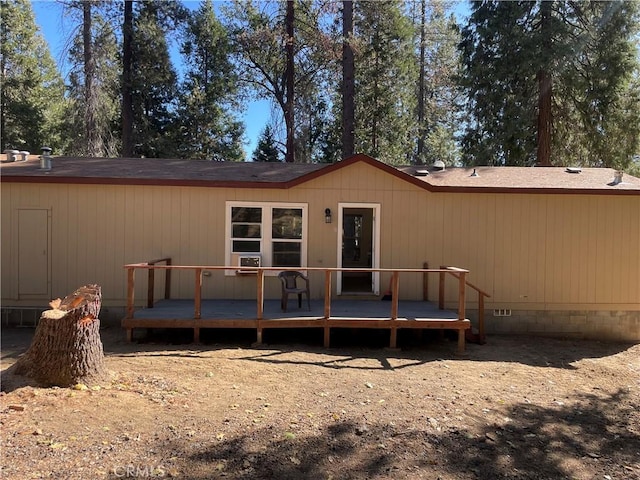 rear view of house featuring crawl space and a deck