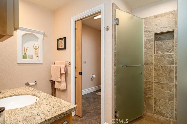 bathroom with vanity, tile patterned flooring, toilet, and an enclosed shower