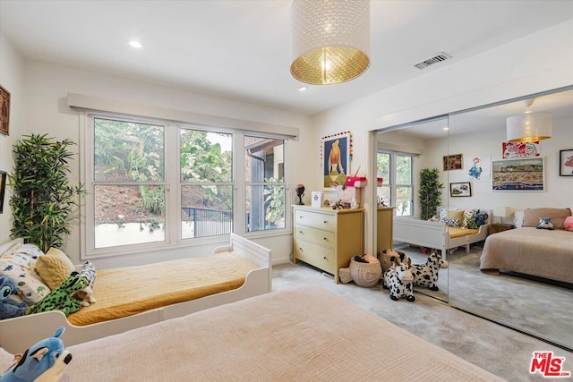 carpeted bedroom featuring multiple windows