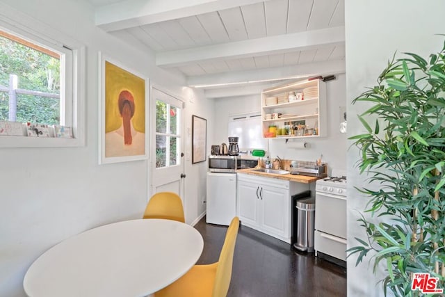 kitchen featuring dark hardwood / wood-style flooring, white appliances, sink, beamed ceiling, and white cabinetry