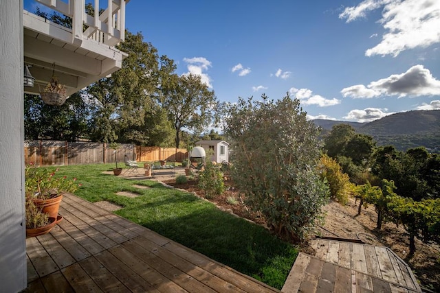 view of yard with a deck with mountain view