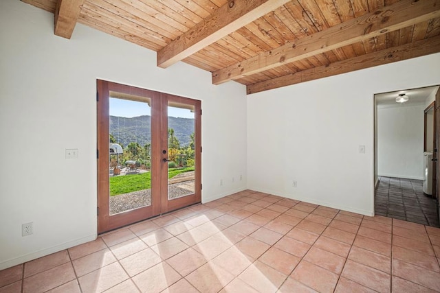 tiled empty room featuring a mountain view, wooden ceiling, beamed ceiling, and french doors