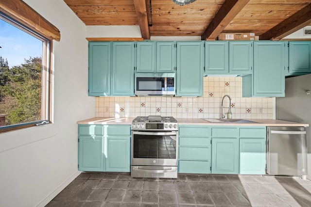 kitchen featuring beam ceiling, a wealth of natural light, stainless steel appliances, and wood ceiling