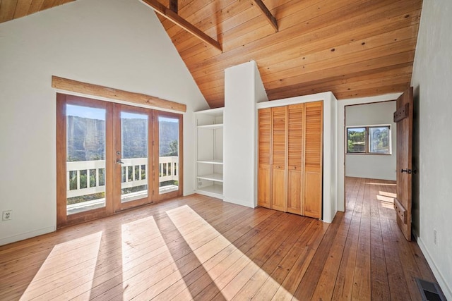 interior space featuring wooden ceiling, high vaulted ceiling, beamed ceiling, and hardwood / wood-style floors