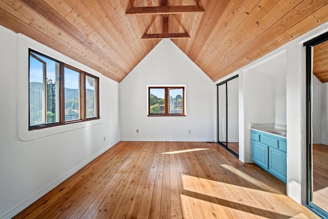 bonus room featuring a wealth of natural light, vaulted ceiling with beams, wood ceiling, and light wood-type flooring