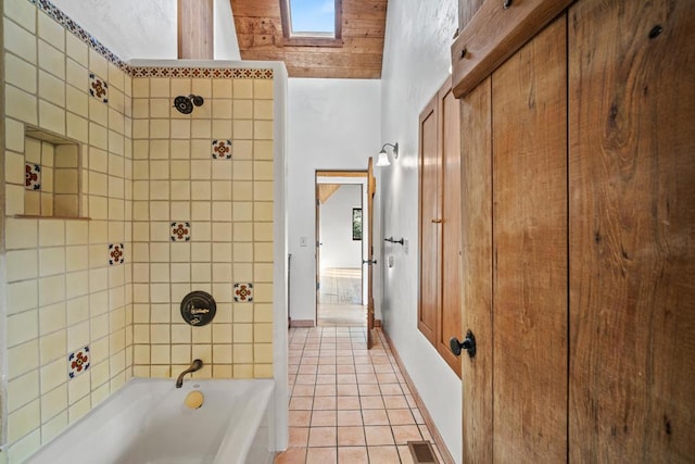 bathroom with tile patterned flooring and tiled shower / bath