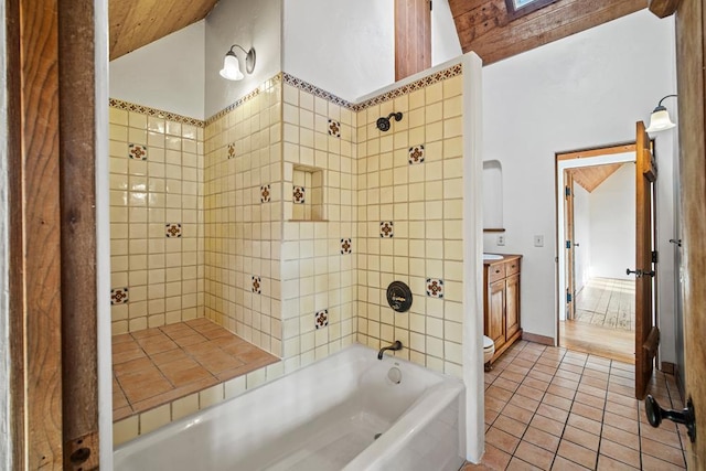 bathroom featuring wood ceiling, tiled shower / bath combo, tile patterned floors, lofted ceiling with skylight, and vanity