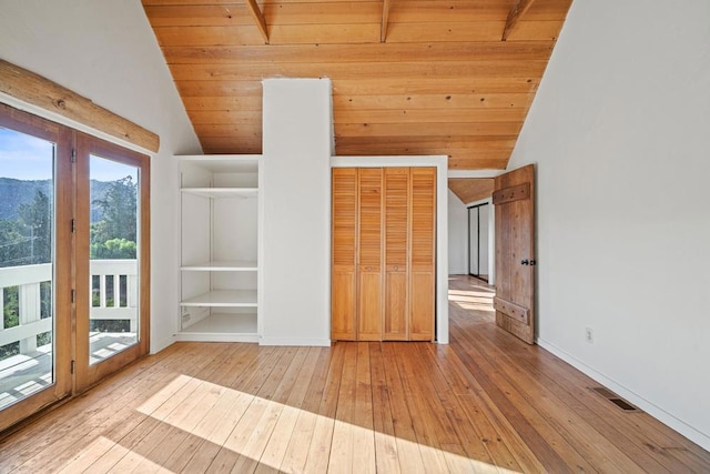 interior space with wood ceiling, a wealth of natural light, and light hardwood / wood-style floors