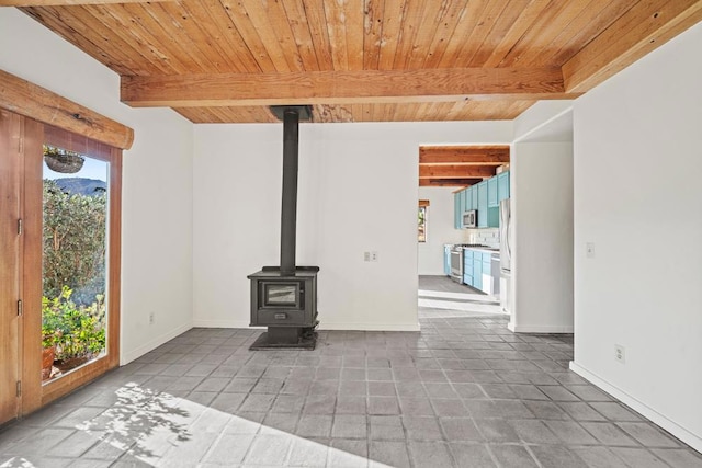 unfurnished living room featuring tile patterned flooring, wood ceiling, beamed ceiling, and a wood stove