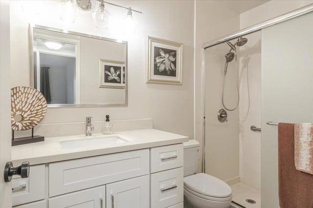 bathroom with vanity, an enclosed shower, and toilet