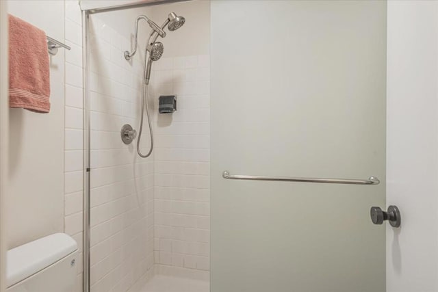 bathroom with tiled shower and toilet